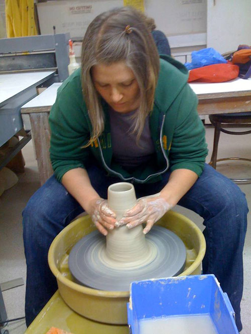 Sara at the pottery wheel.