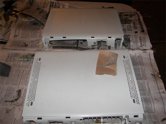 Prepping the surface of an XBox 360 to get wrapped in carbon fiber