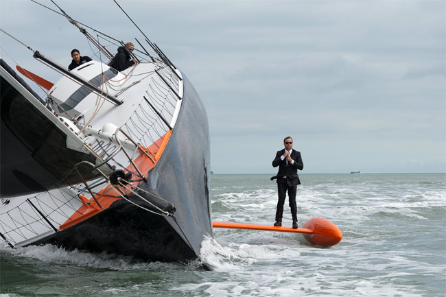 Alex Thompson standing on the keel of the Hugo Boss yacht